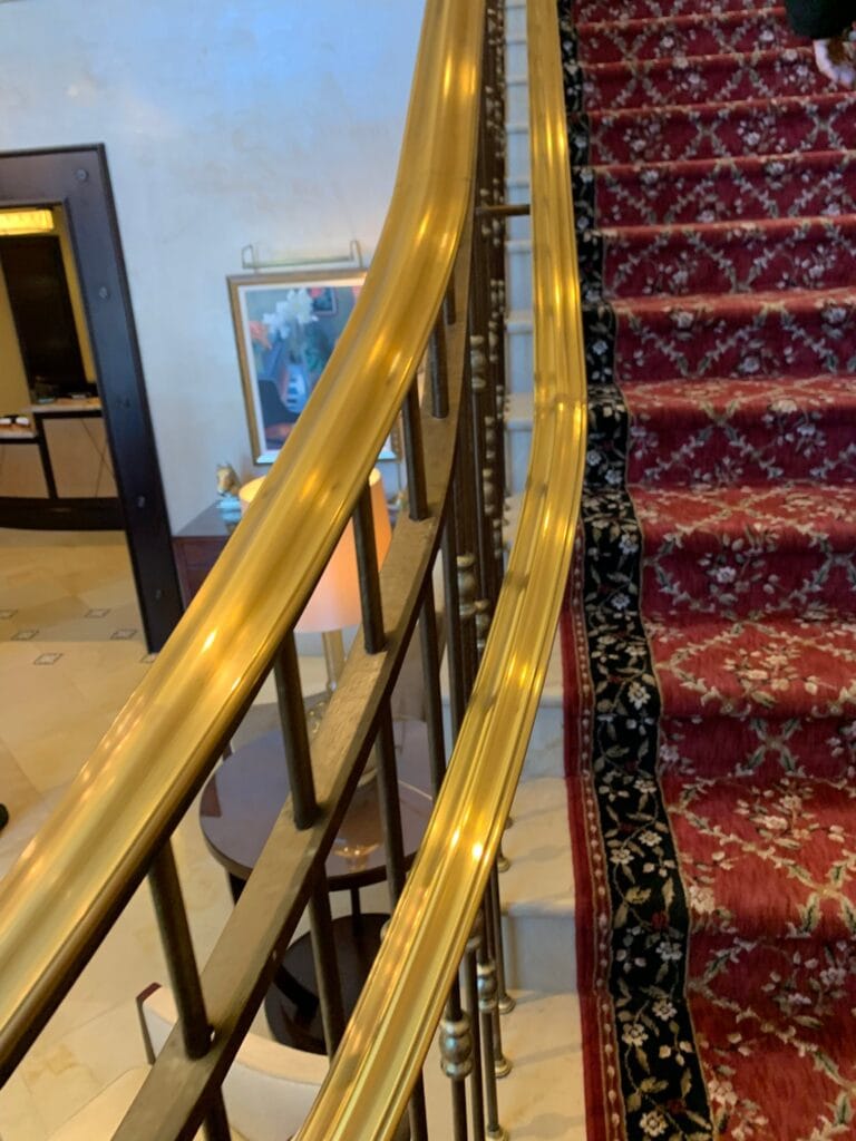 Polished brass stair railing in a home