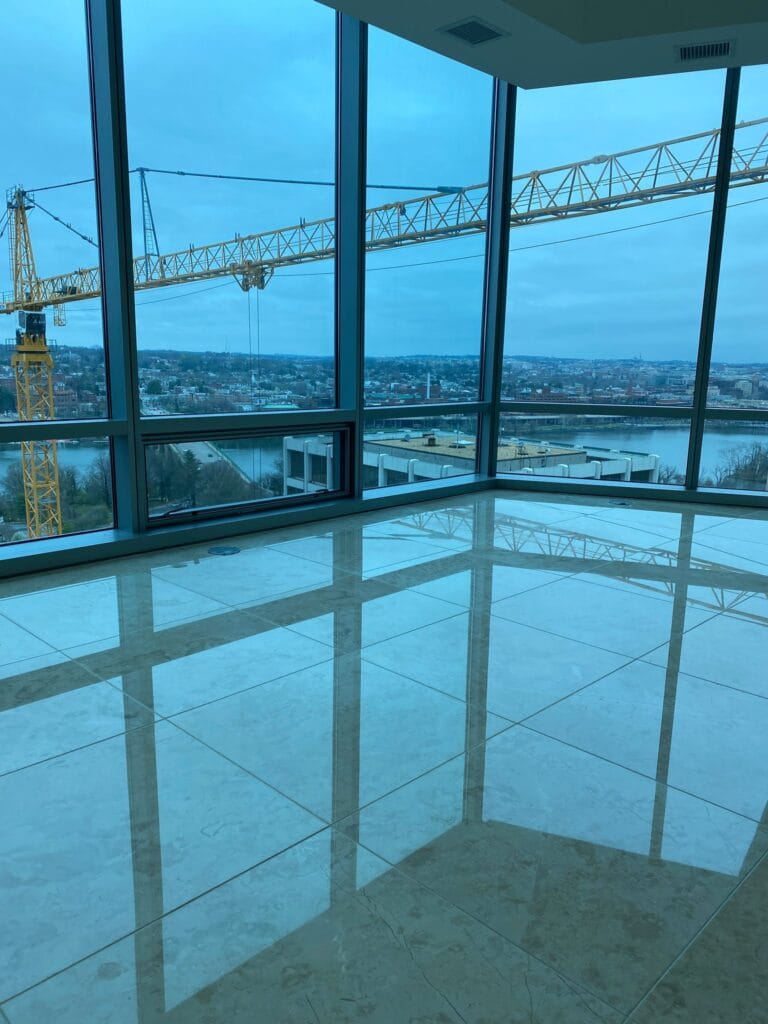 Polished floor reflecting tall windows
