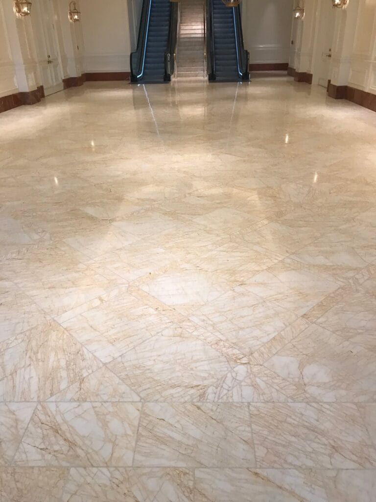 Polished marble floor at the foot of an escalator