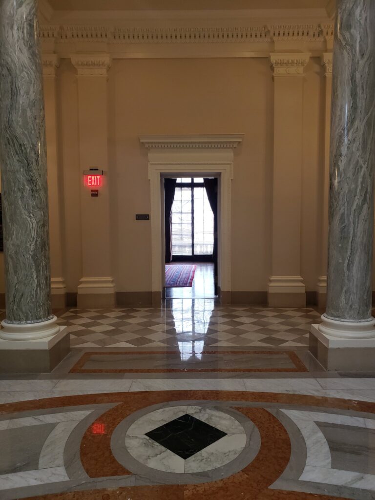 Polished marble floor with a colored inlay in a formal hall