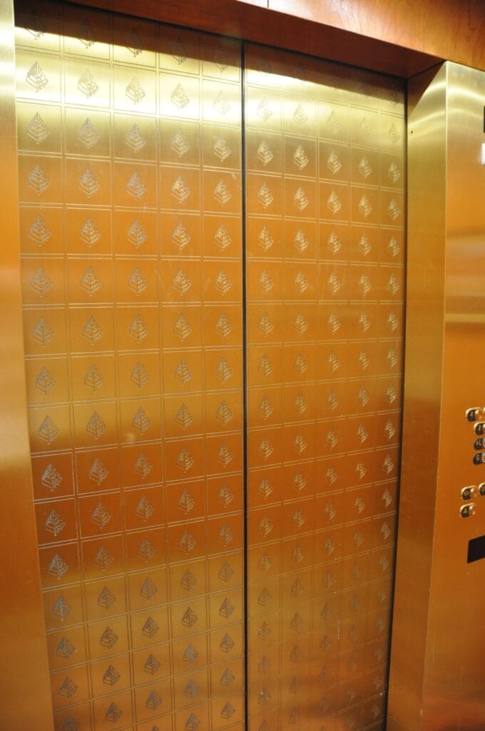 Polished patterned brass elevator doors