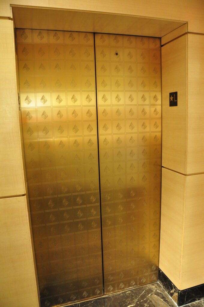 Polished patterned brass elevator doors