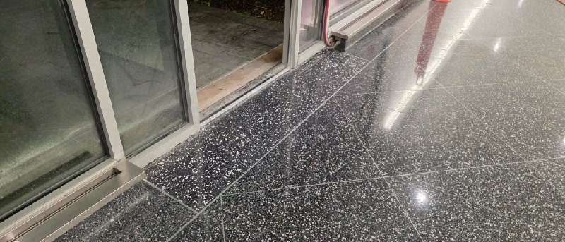 Polished speckled stone floor from a Rose Restoration job in Bethesda, MD