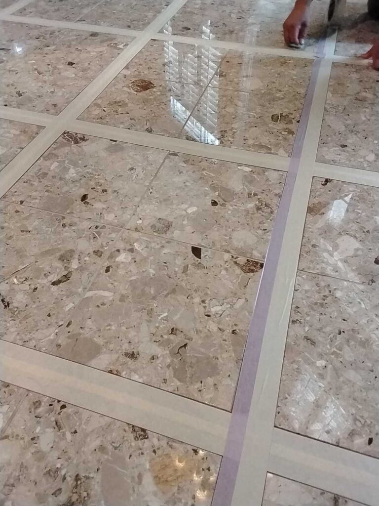 Polished stone floor with grout lines from a Rose Restoration job in Woodbridge, VA