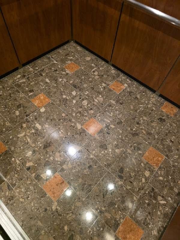 Polished stone floor with patterned tiles from a Rose Restoration job in N Bethesda, MD