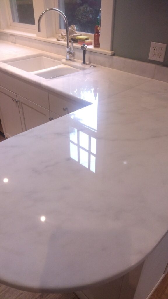 Polished white countertop with an undermount sink