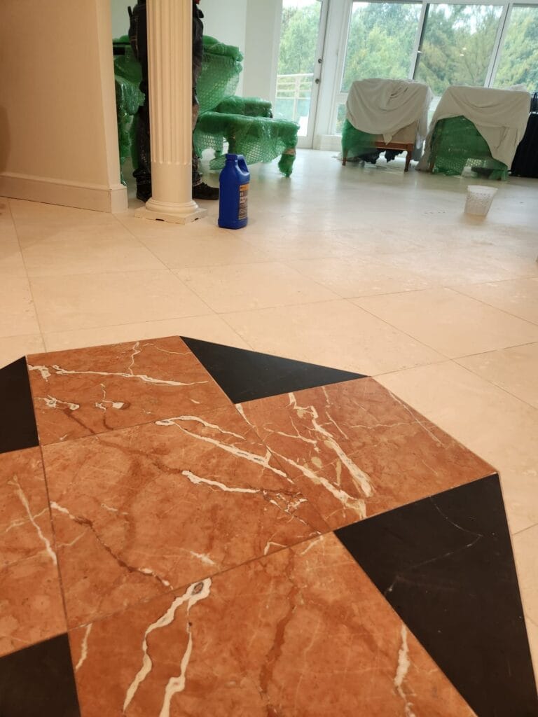 Red marble floor inlay with black borders
