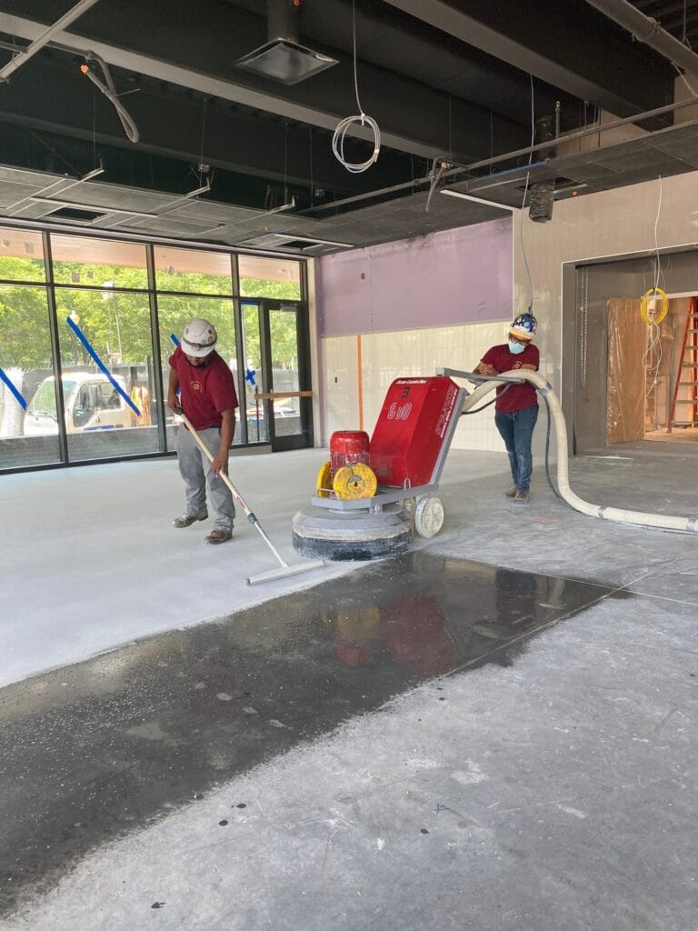 Rose crew grinding a concrete floor in a commercial space