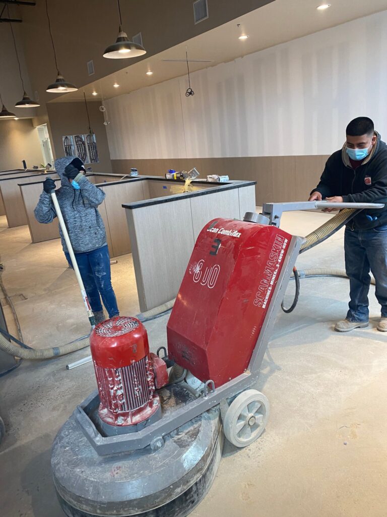 Rose crew grinding a concrete floor with a planetary grinder