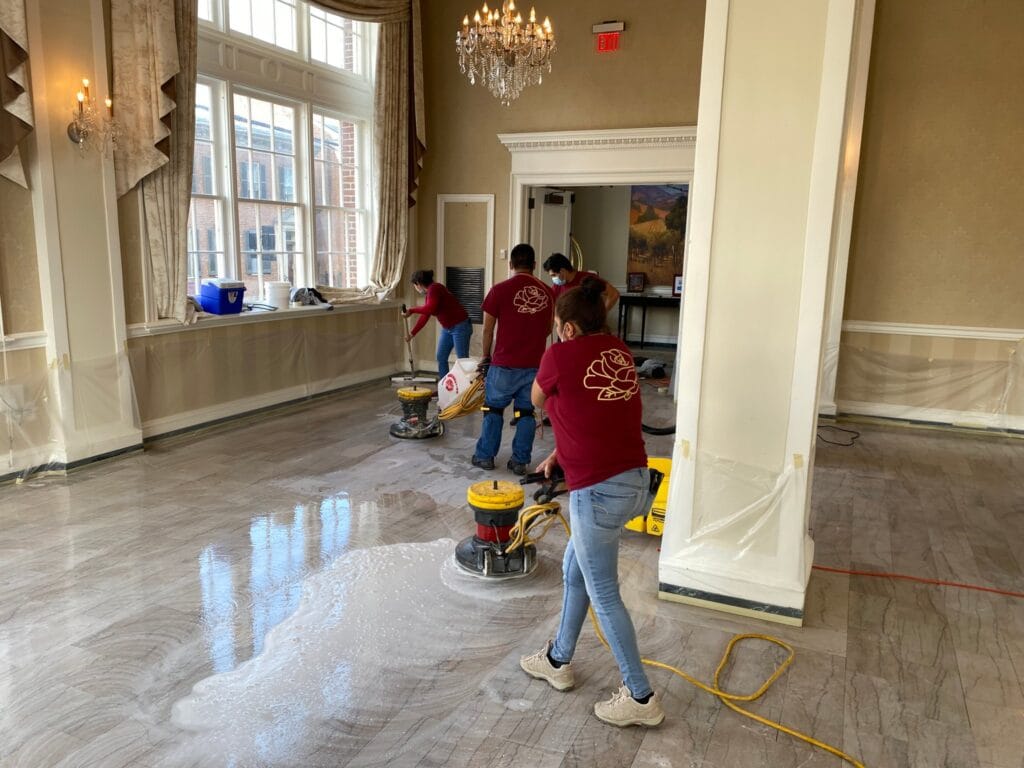 Rose crew polishing a marble floor in a large bright room