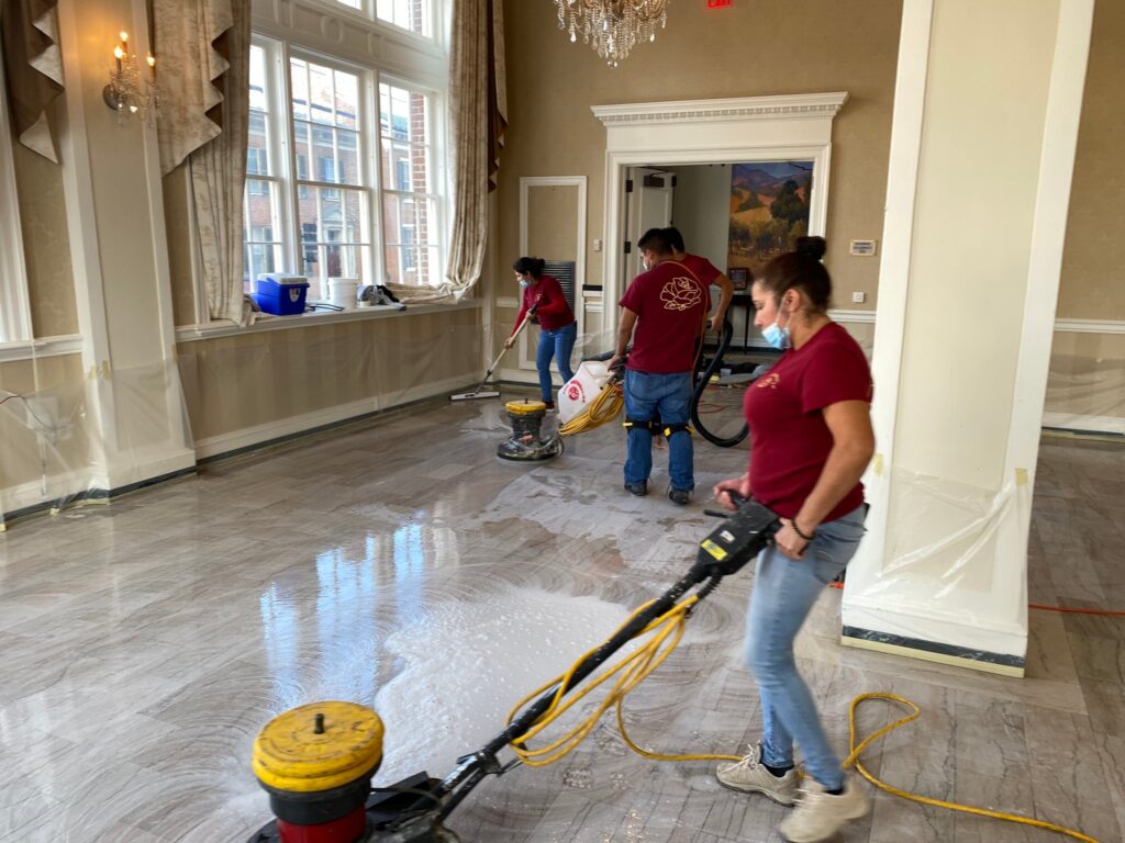 Rose crew polishing a marble floor in a large hall