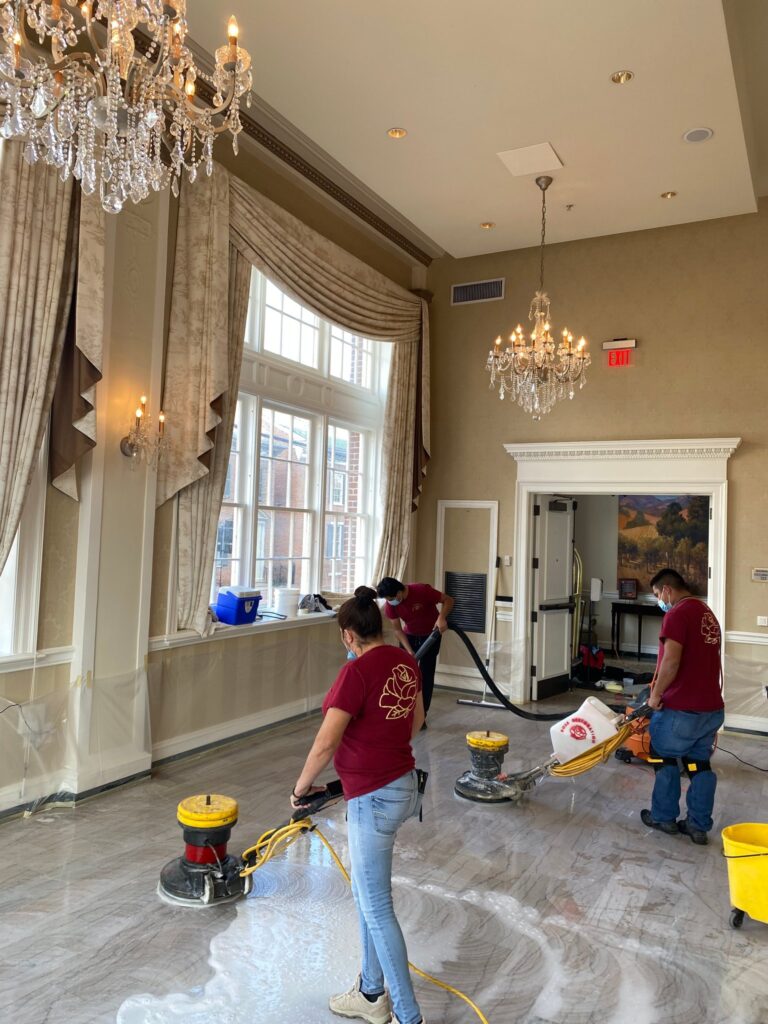 Rose crew polishing a marble floor in a large room