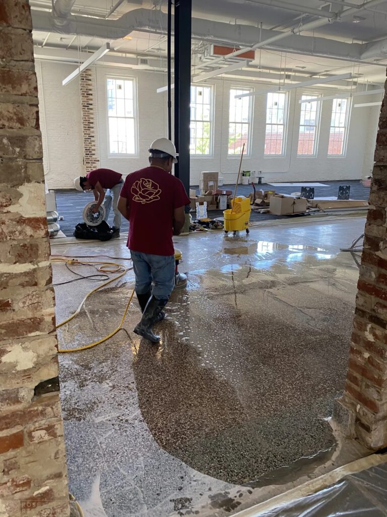 Rose Restoration crew grinding a terrazzo floor in a historic building