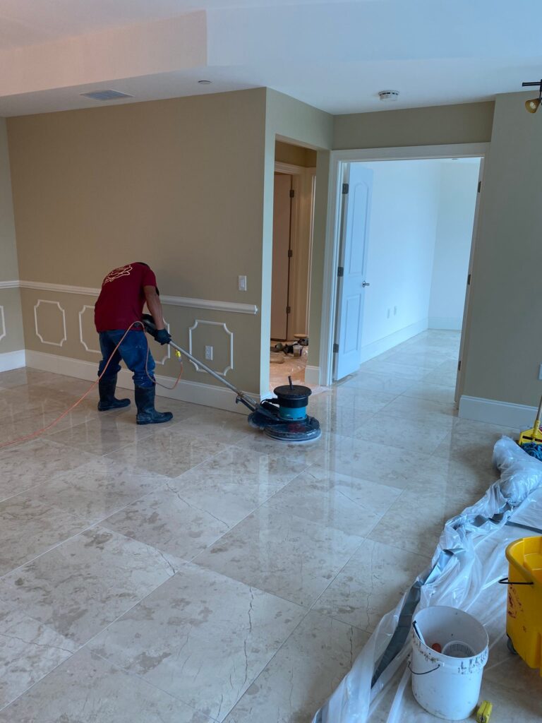 Rose technician cleaning a marble floor in a home