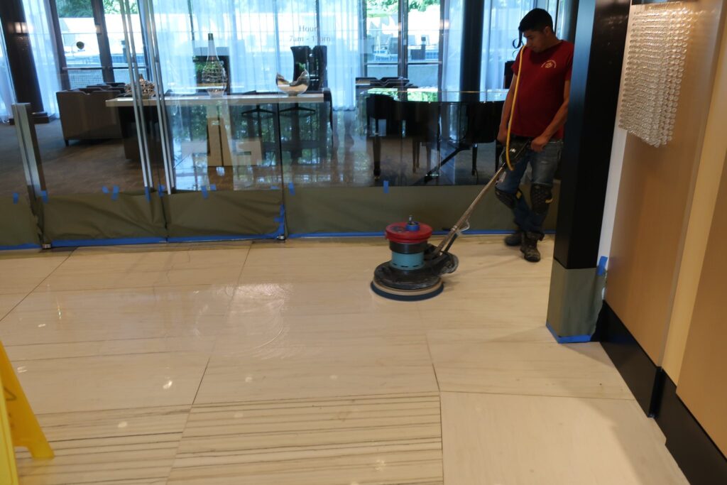 Rose technician maintaining a stone floor with a floor machine
