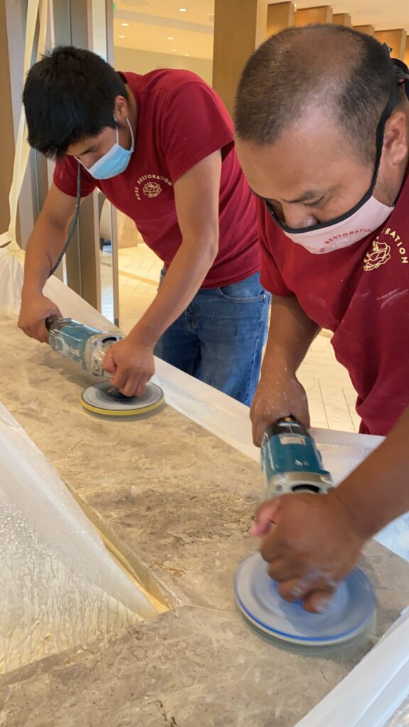Rose technicians polishing a countertop