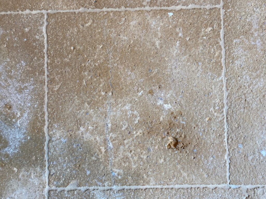 Stone floor tile with natural pits