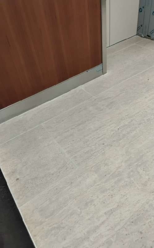 Stone floor with wood paneling edge from a Rose Restoration job in Washington, DC