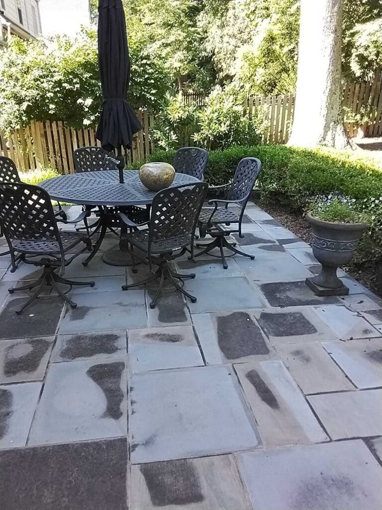 Stone patio with metal furniture from a Rose Restoration job in Alexandria, VA