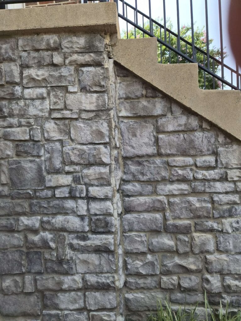 Stone wall with metal railing above from a Rose Restoration job in Alexandria, VA