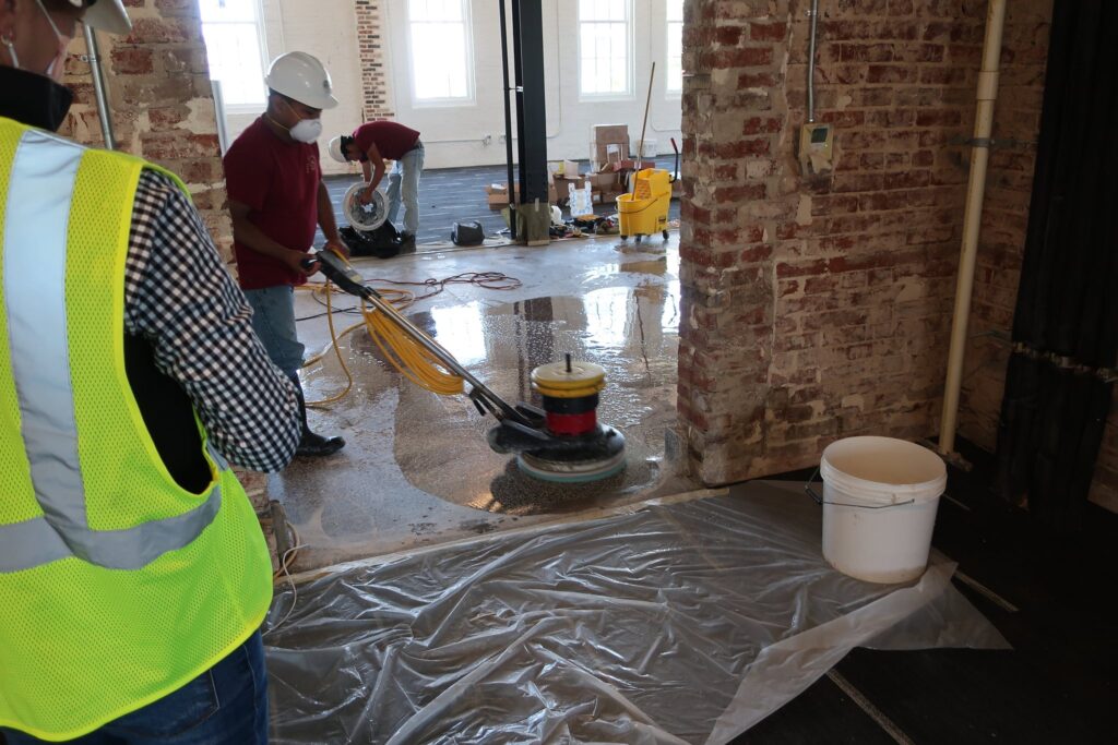 Technician polishing a floor with a machine