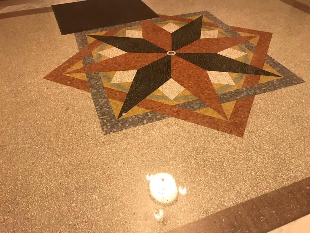 Terrazzo floor with a compass-star inlay