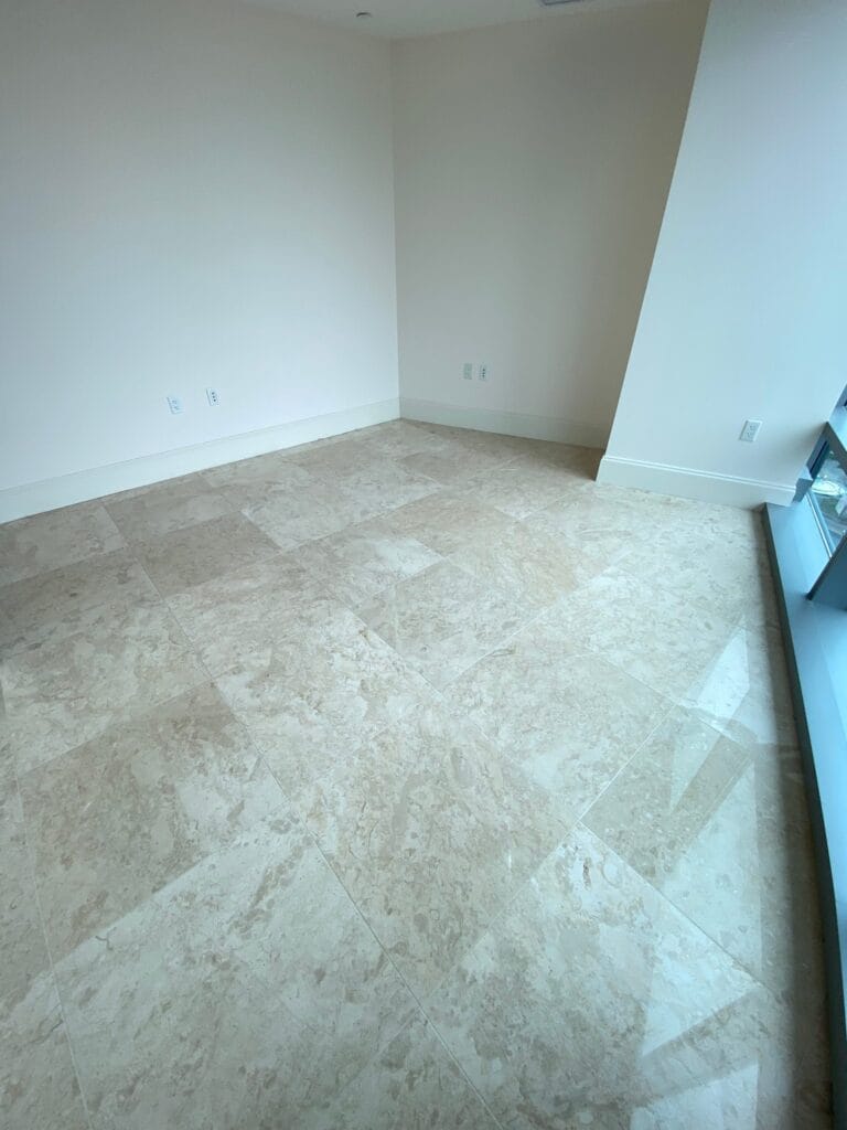Travertine tile floor in an empty room after cleaning
