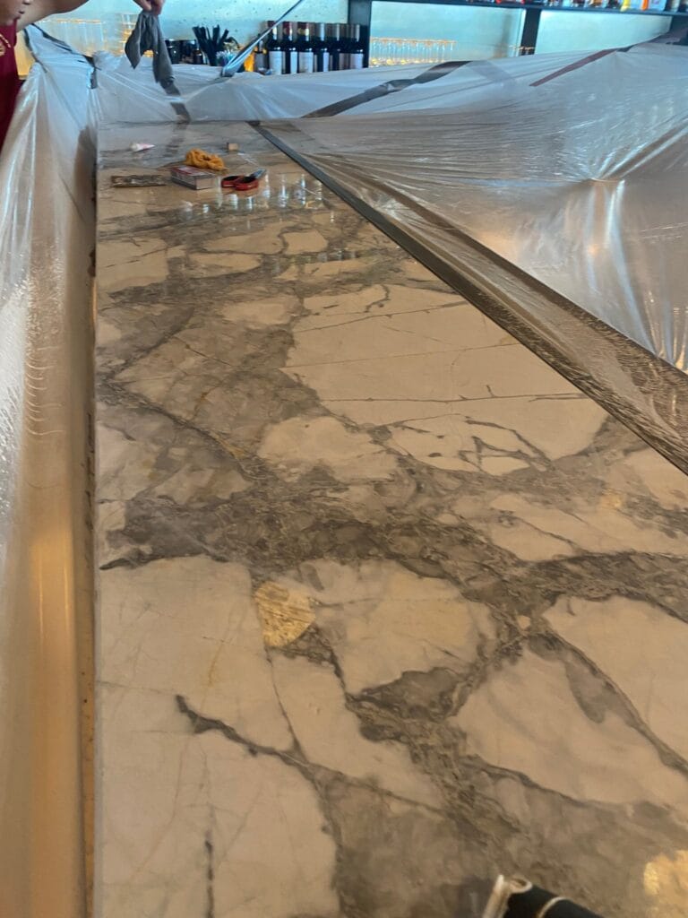 Veined stone bar top protected with plastic during work