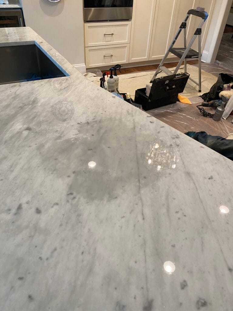 Water mark and dull spots on a white marble countertop
