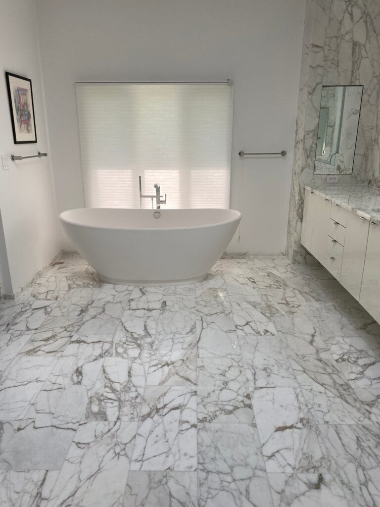 White marble bathroom floor with a freestanding tub