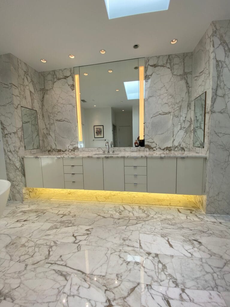 White marble bathroom with marble walls and vanity