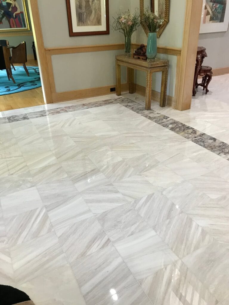 White marble floor with a dark border