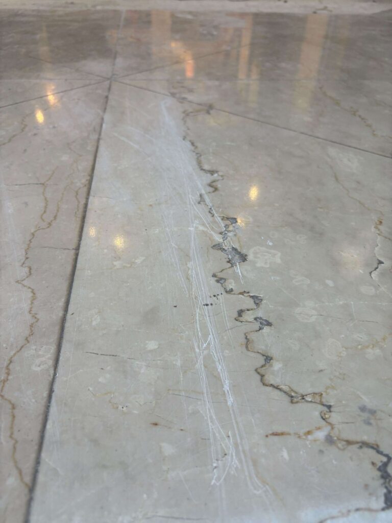 Stone floor with scratches and cracks, Rose Restoration project