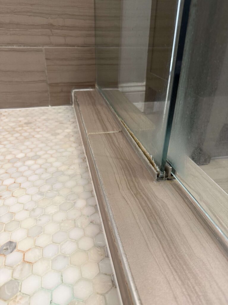 Stone shower base with glass door, Rose Restoration project