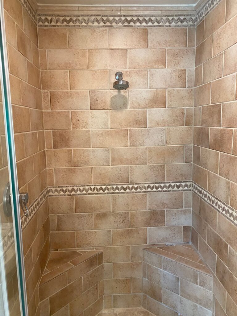 Stone shower stall with built-in bench, Rose Restoration project