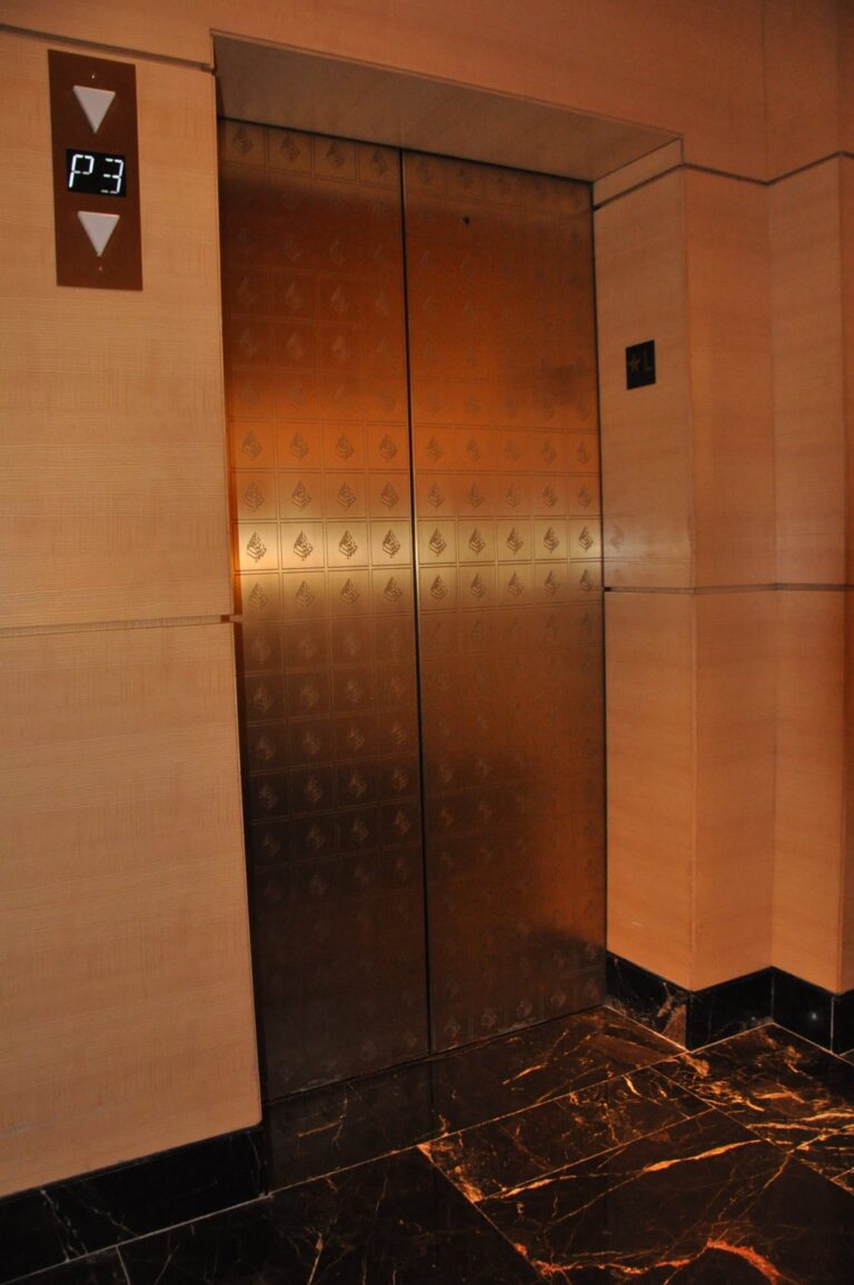Metallic elevator doors with patterned surface, Rose Restoration project