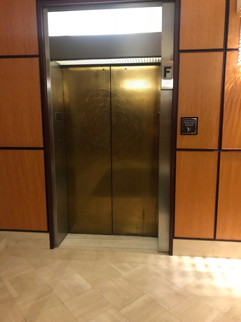 Metallic elevator doors with patterned finish, Rose Restoration project
