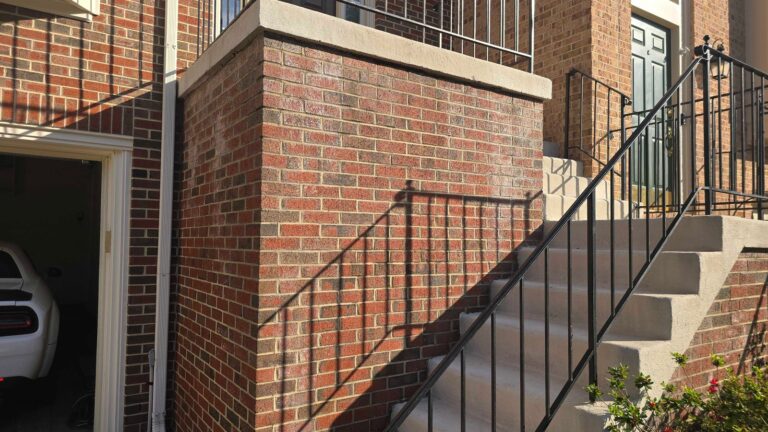 Red brick wall with metal railing, Rose Restoration project