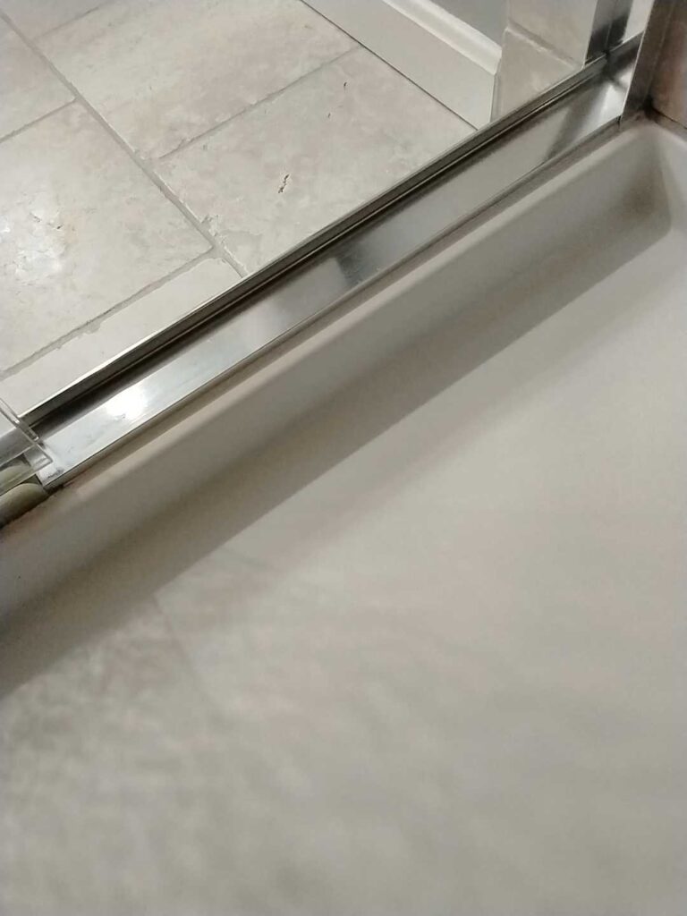 Stone shower floor with metal trim, Rose Restoration project