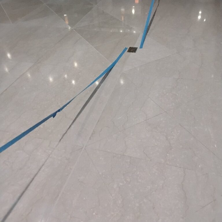 Polished stone floor with blue tape, Rose Restoration project