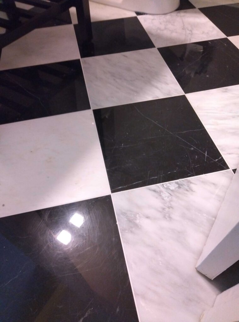 Before: black and white checkerboard floor in McLean, VA, photographed by Rose Restoration before the work