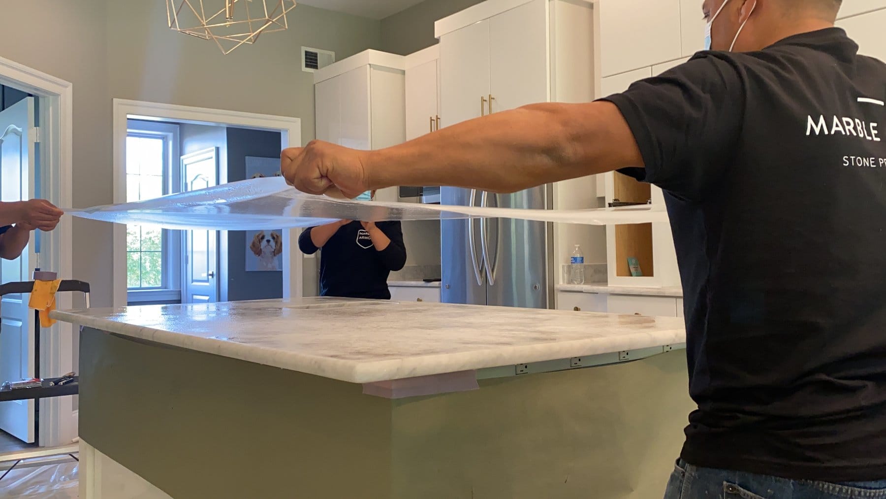 Clear Marble Armor film being rolled out over a marble island
