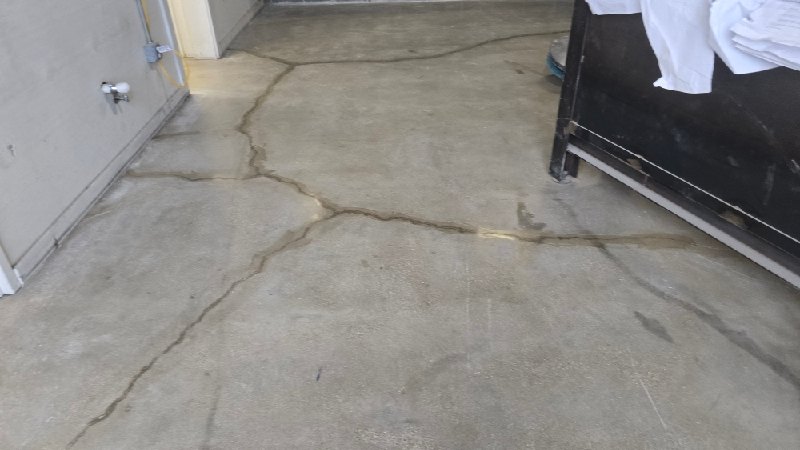 Before: cracked concrete floor, polished in Washington, DC, photographed by Rose Restoration before the work