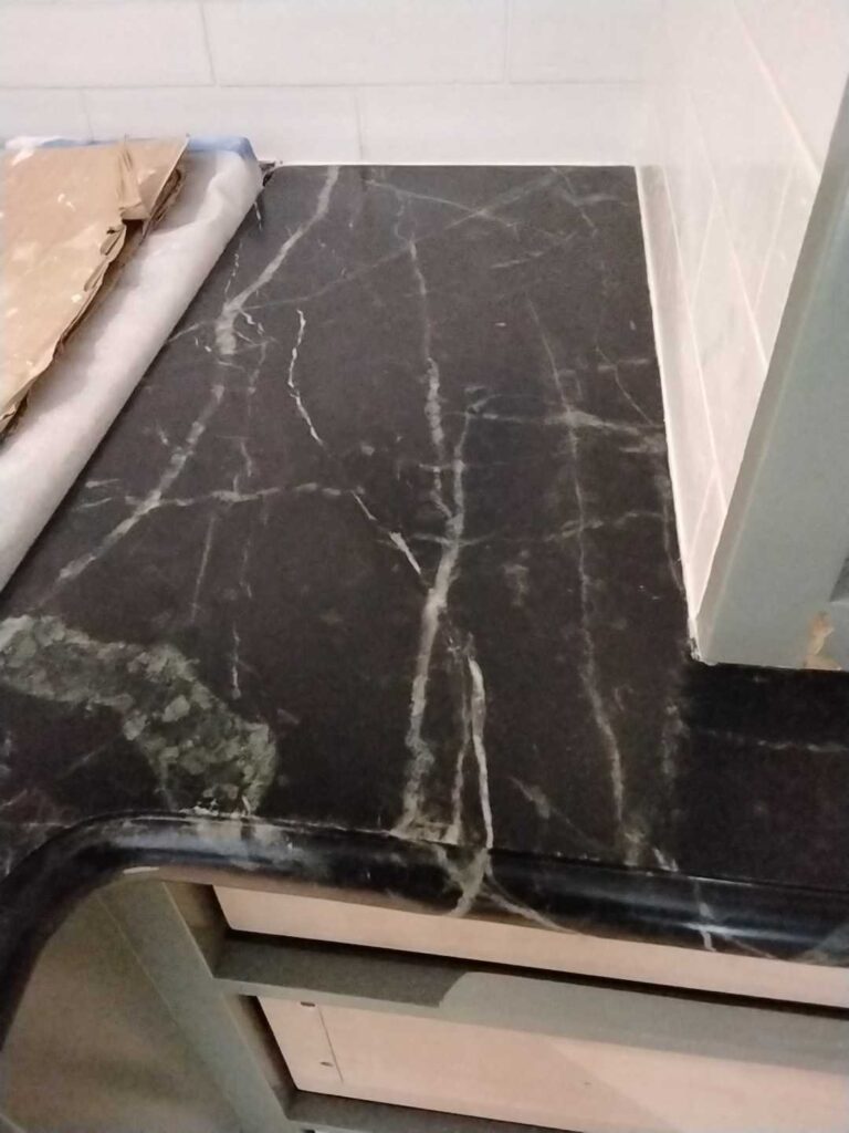 Dark marble countertop with veining, Rose Restoration project
