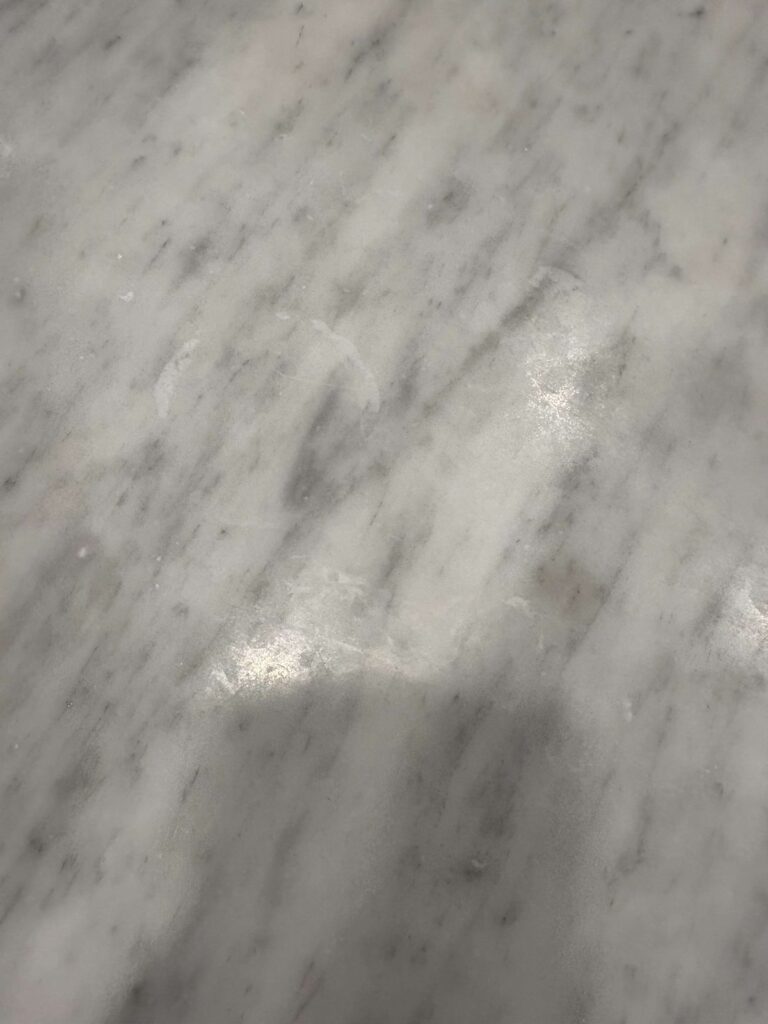 After: the same marble kitchen countertop in Washington, DC after Rose Restoration's work