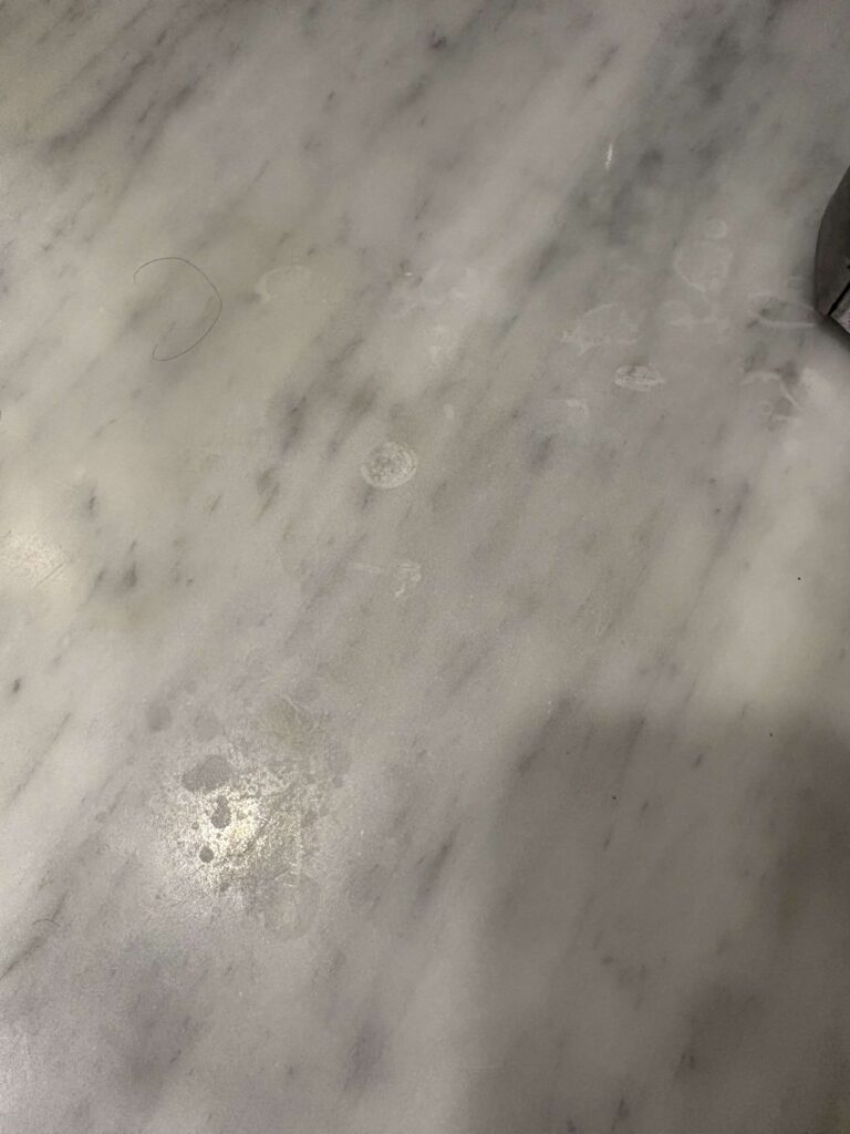 Before: marble kitchen countertop in Washington, DC, photographed by Rose Restoration before the work