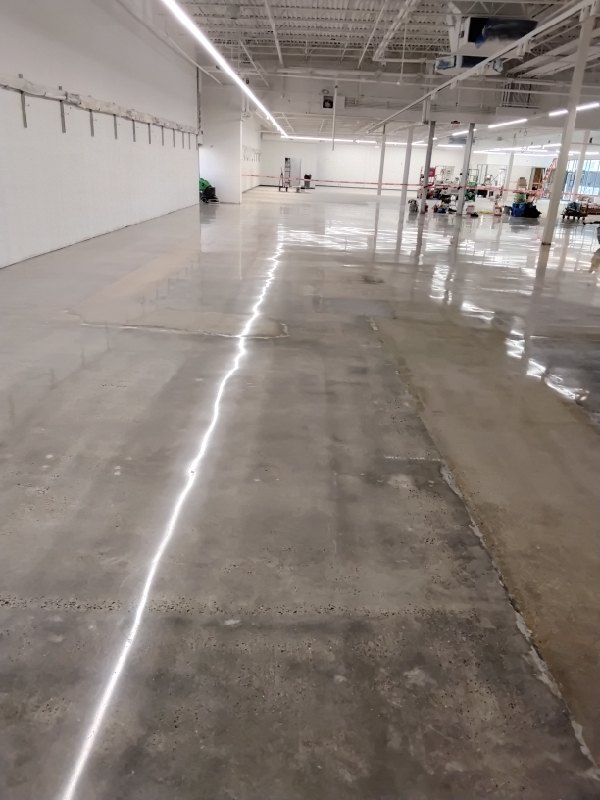 Polished concrete beside a patched area, Lidl Falls Church, 2026