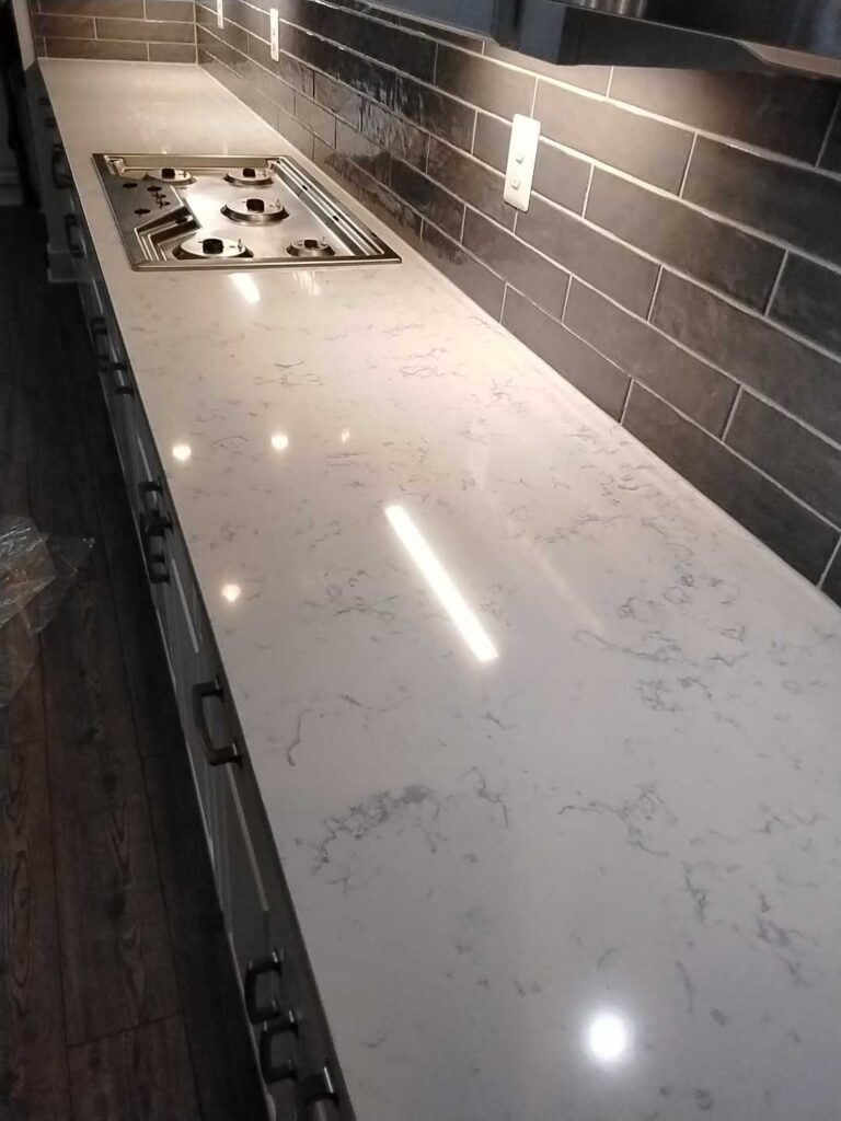 Polished stone countertop with gas cooktop, Rose Restoration project