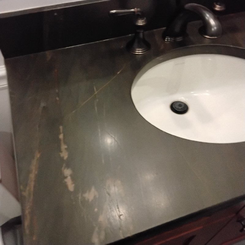 Before: quartzite vanity top in Gaithersburg, MD, photographed by Rose Restoration before the work