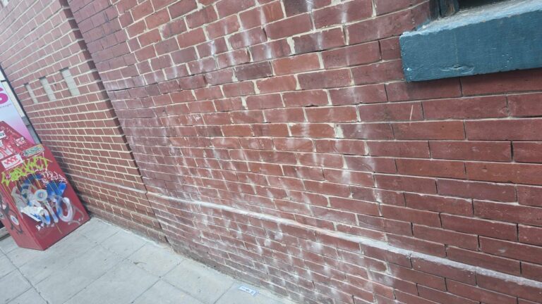 Red brick wall with mortar joints, historic facade in Washington, DC, Rose Restoration project